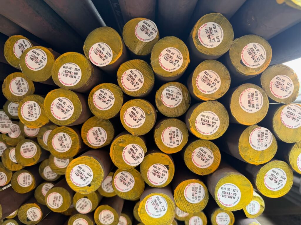Close-up of yellow-coded round bar ends with heat-number tags