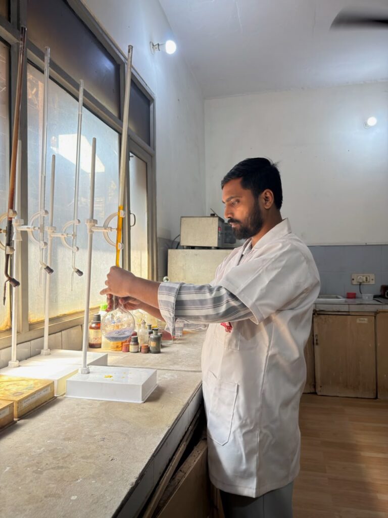 Chemist performing wet chemical analysis at the lab bench