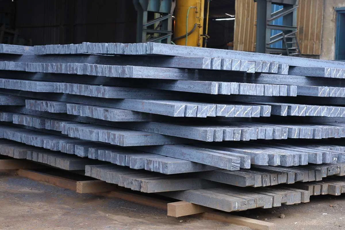 Forging-quality steel billets stacked on timber in the yard